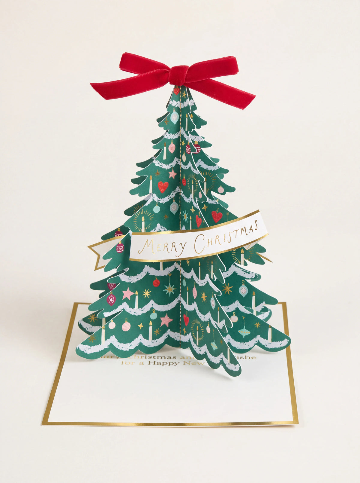Standing 3D Christmas tree card topped with a red velvet bow and a banner reading Merry Christmas