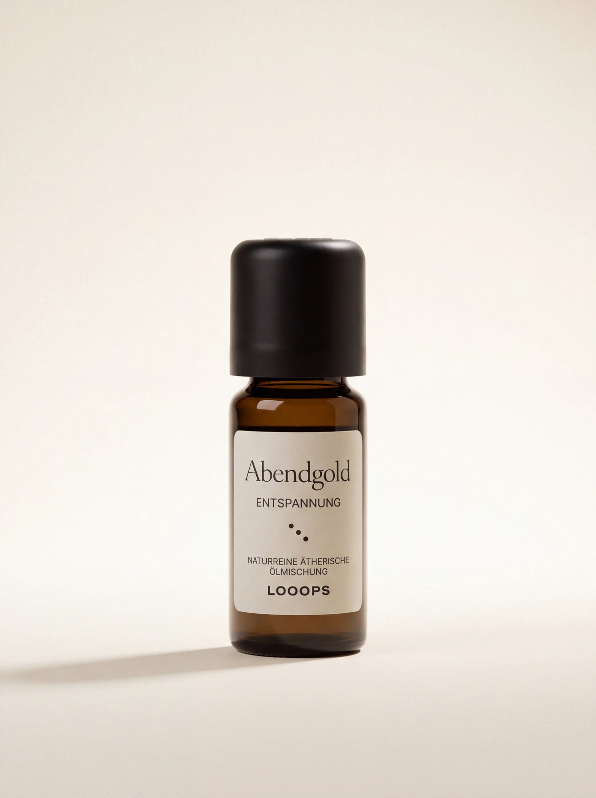Amber glass essential oil bottle with a black cap and white label reading Abendgold ENTSPANNUNG
