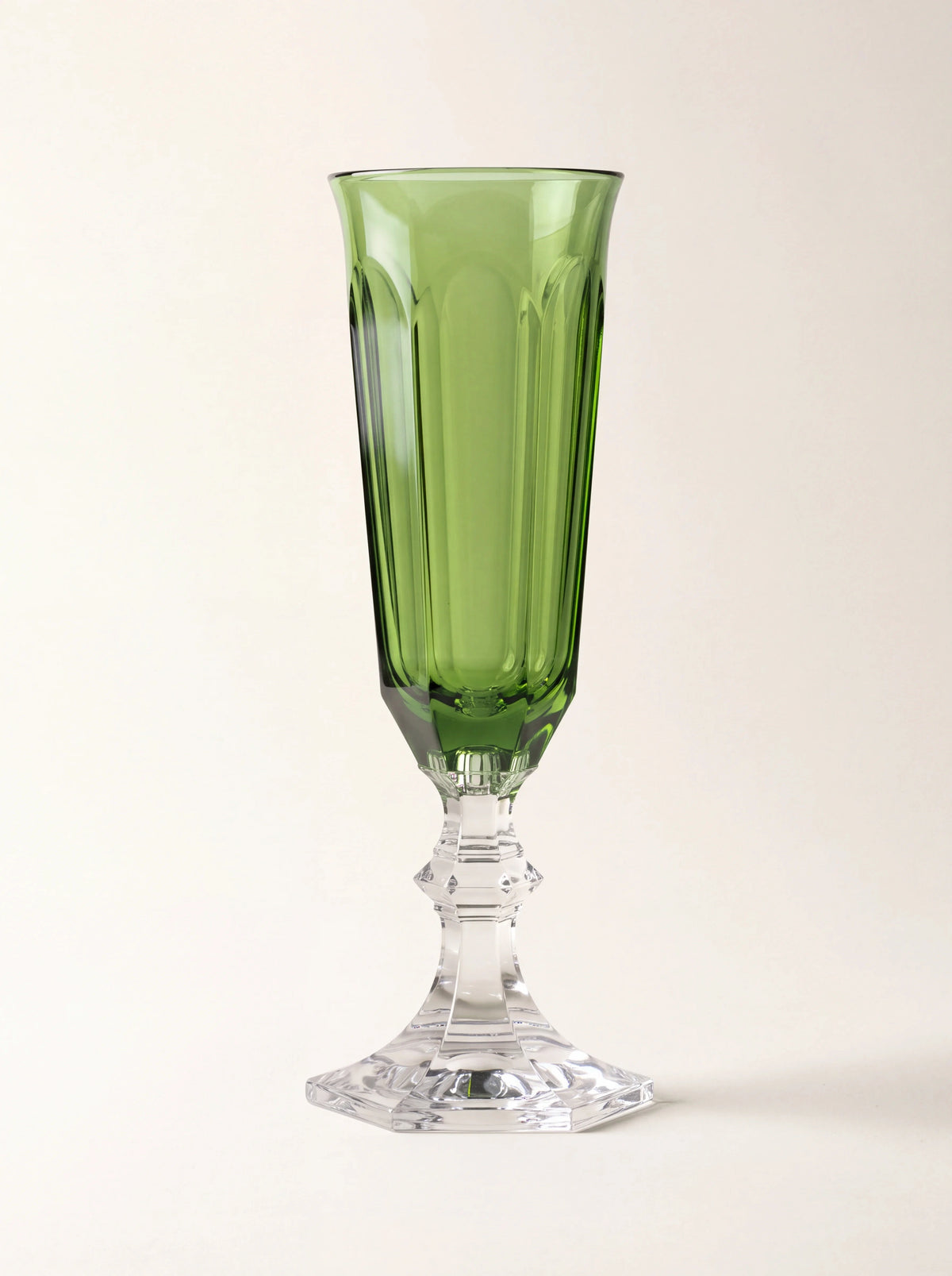 Green acrylic champagne flute with a faceted bowl and clear faceted stem and foot
