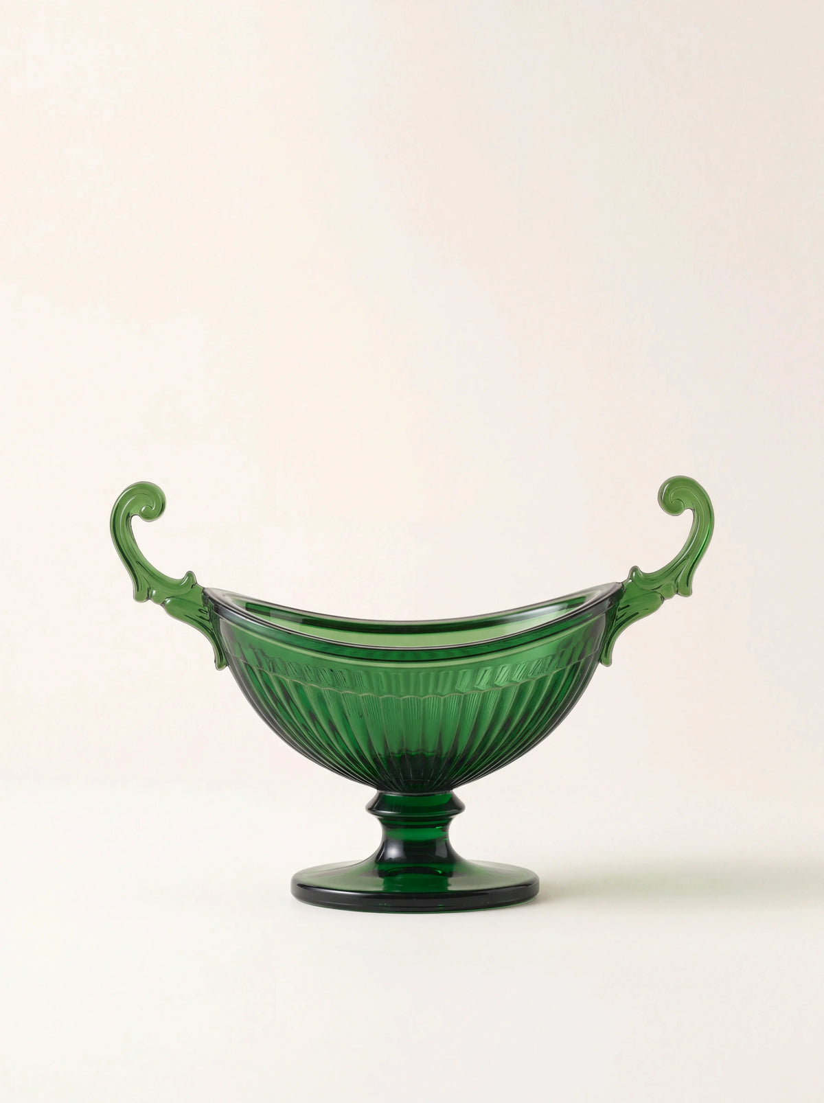 Green acrylic salt cellar with a fluted bowl, two curved scrolled handles and a pedestal base