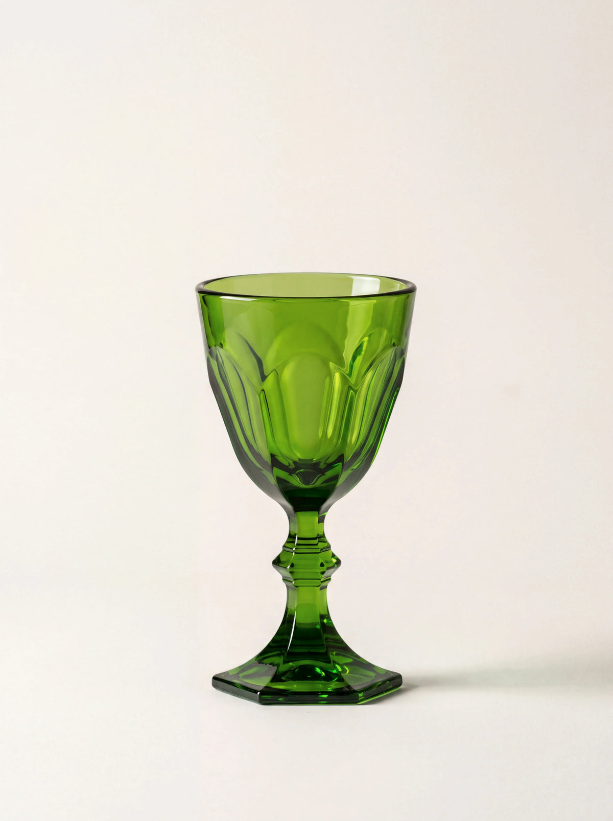 Green acrylic stemmed shot glass with a faceted bowl, sculpted stem and hexagonal base
