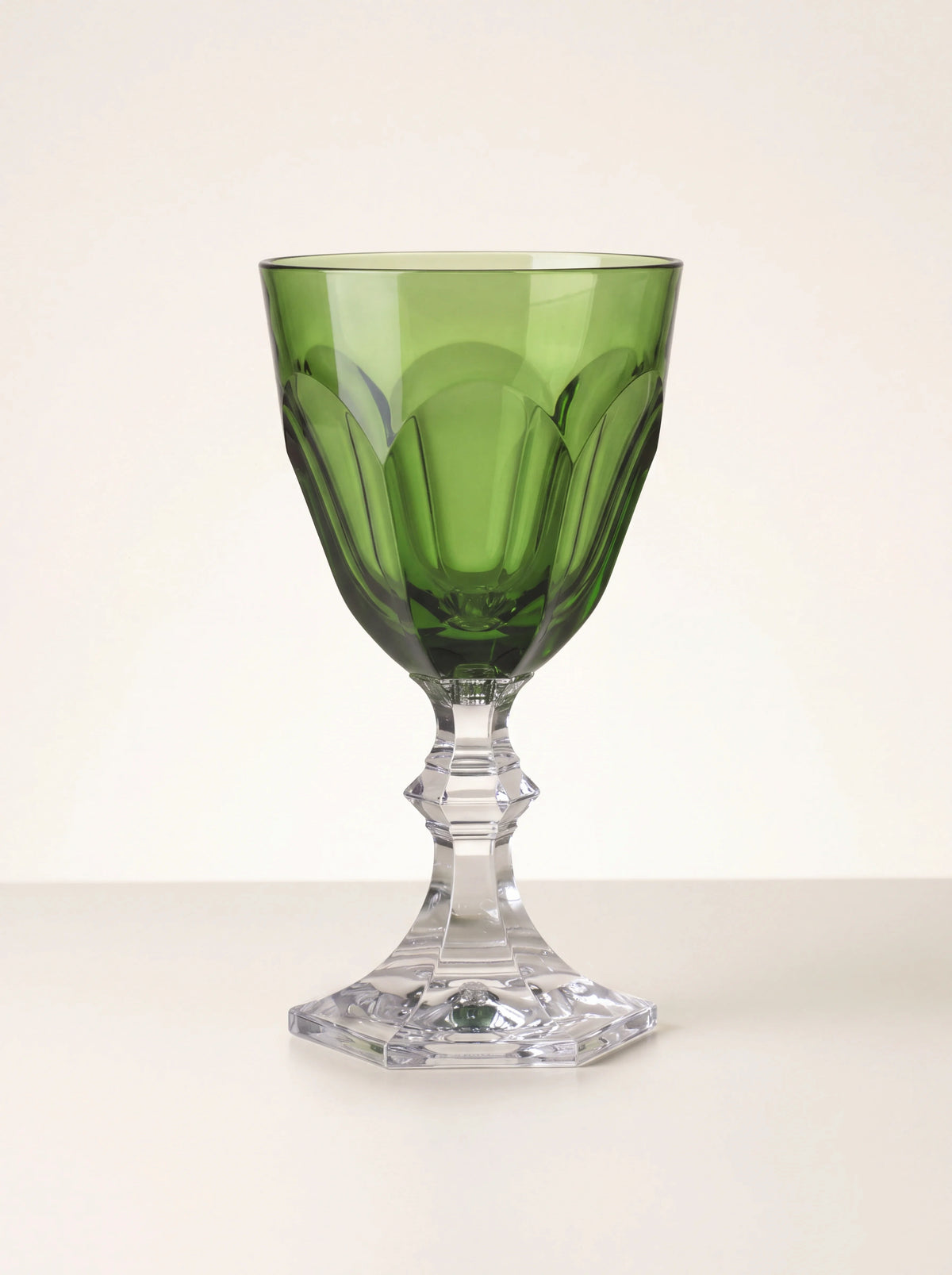Green acrylic wine glass with a faceted bowl, clear faceted stem and octagonal base