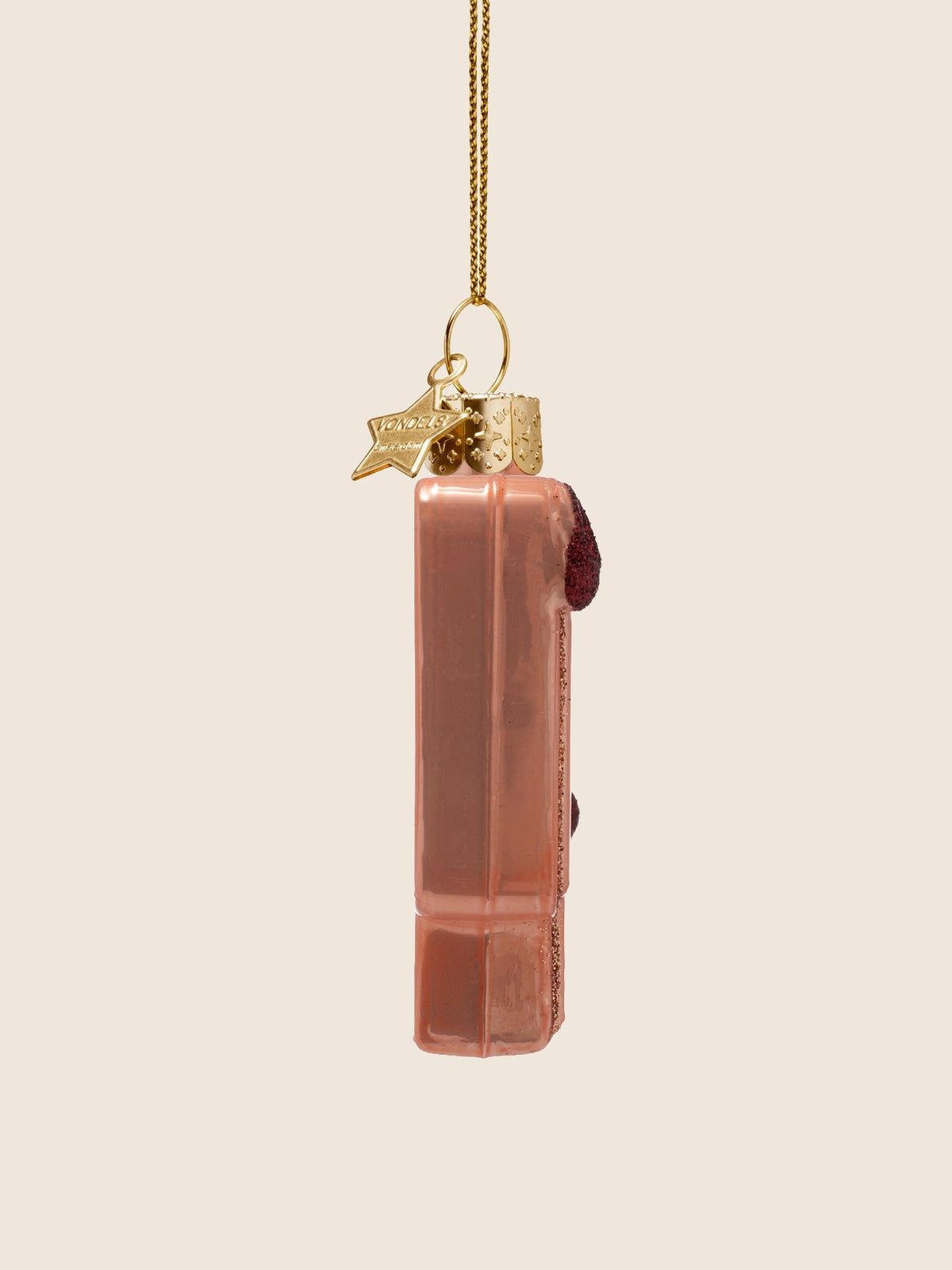 Speech bubble glass ornament seen from the side, showing its narrow profile and raised glitter details