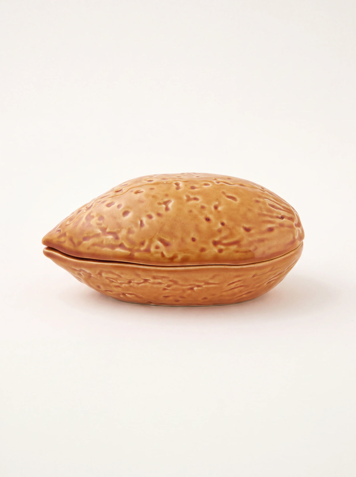 Almond-shaped glazed earthenware box with a textured brown shell pattern and closed lid