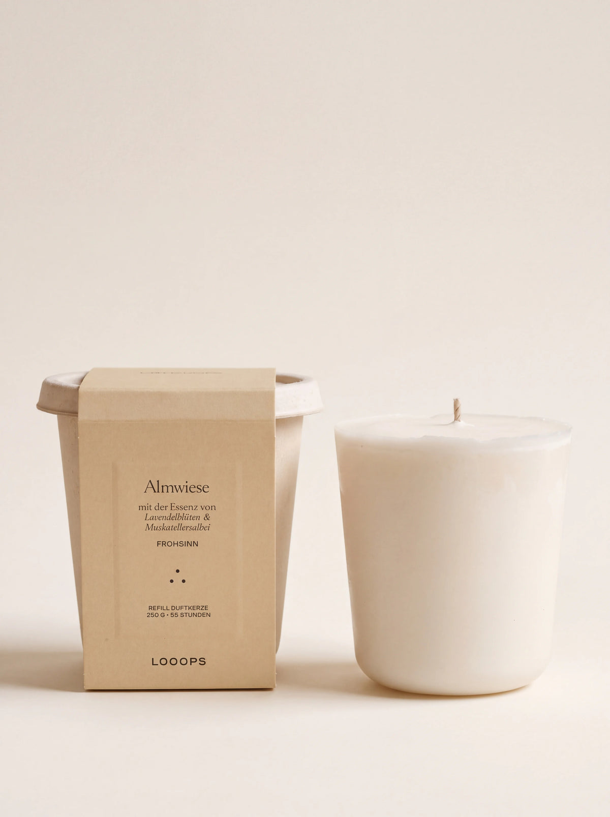 White vegetable wax scented candle refill with a single wick, beside its bagasse cup packaging