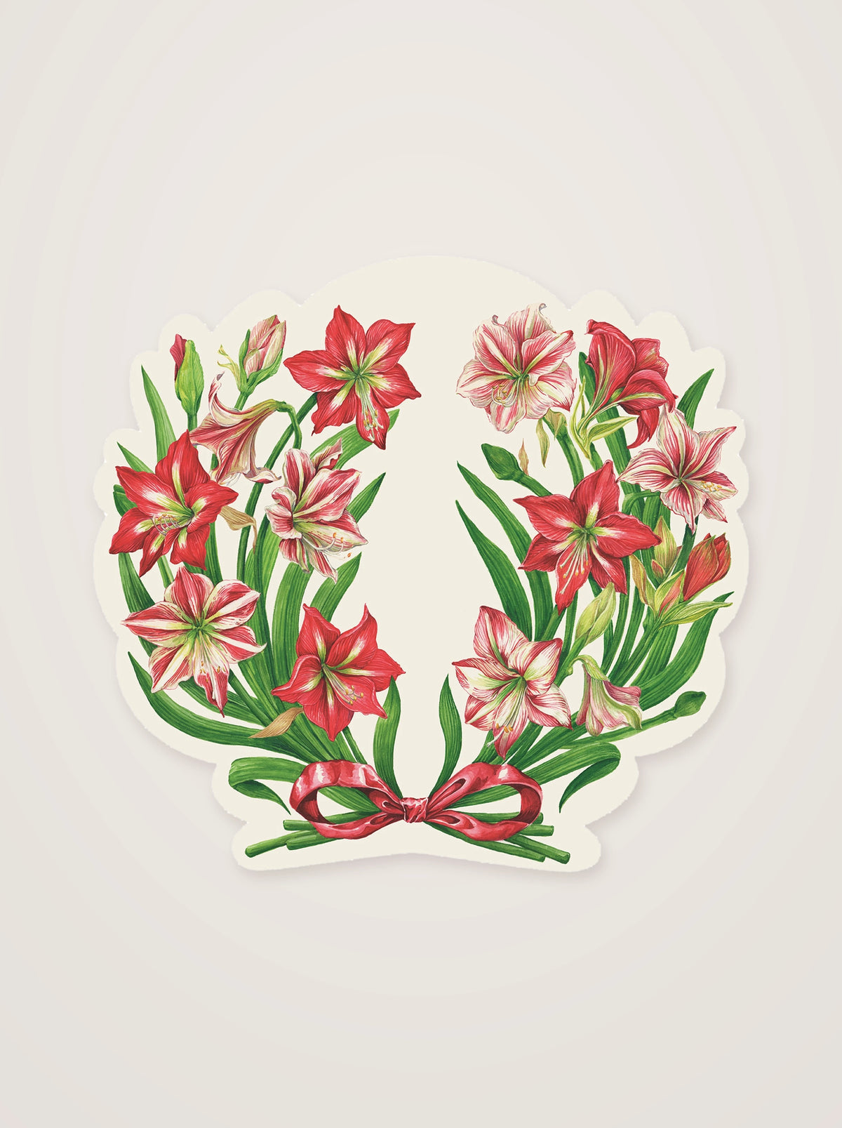 Amaryllis paper placemat die-cut in a wreath design with red and pink-striped blooms, green stems and a ribbon
