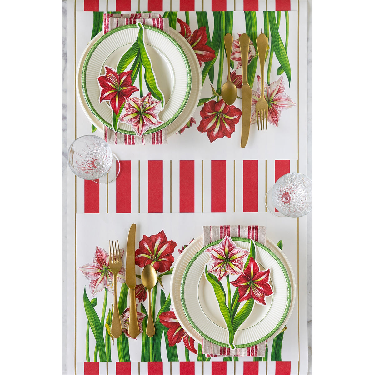 Two-person table setting showing the amaryllis paper placemats laid opposite each other