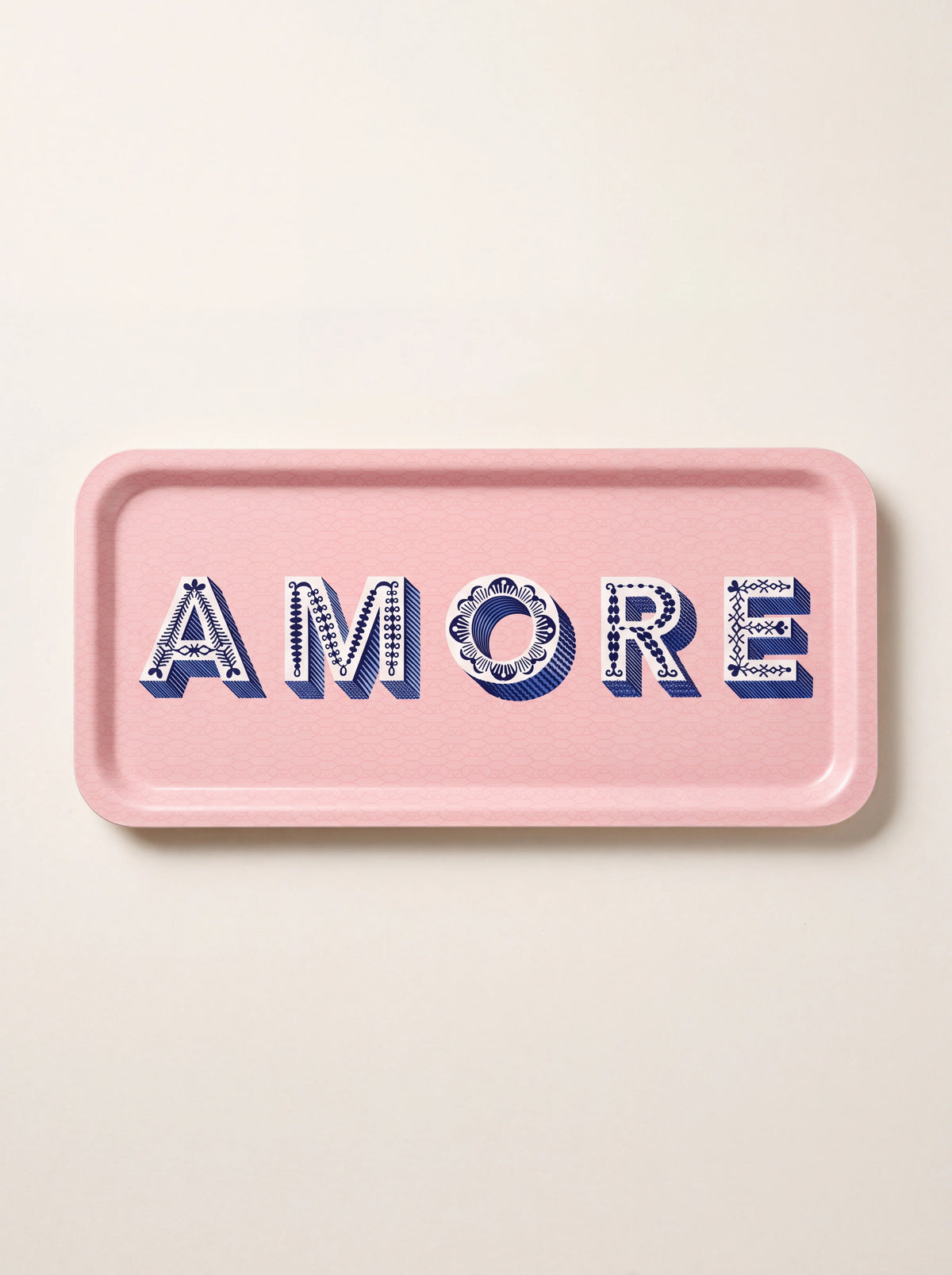 Light pink birch wood tray with a raised rim and patterned blue lettering spelling AMORE