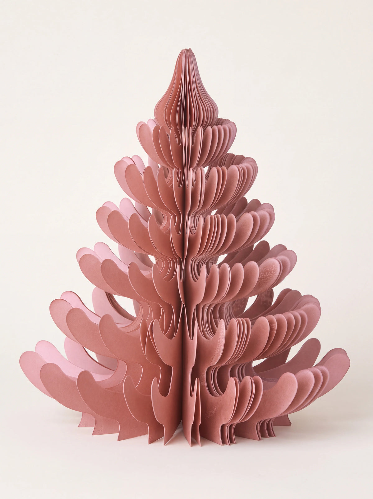 Dusty rose paper honeycomb tree unfolded into a tiered standing shape