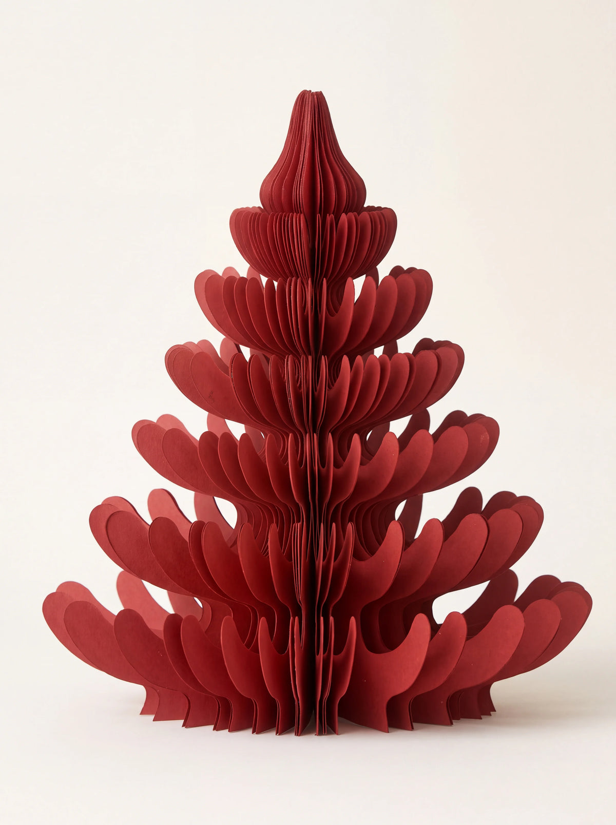Ruby red paper tree unfolded into a tiered, curved honeycomb structure