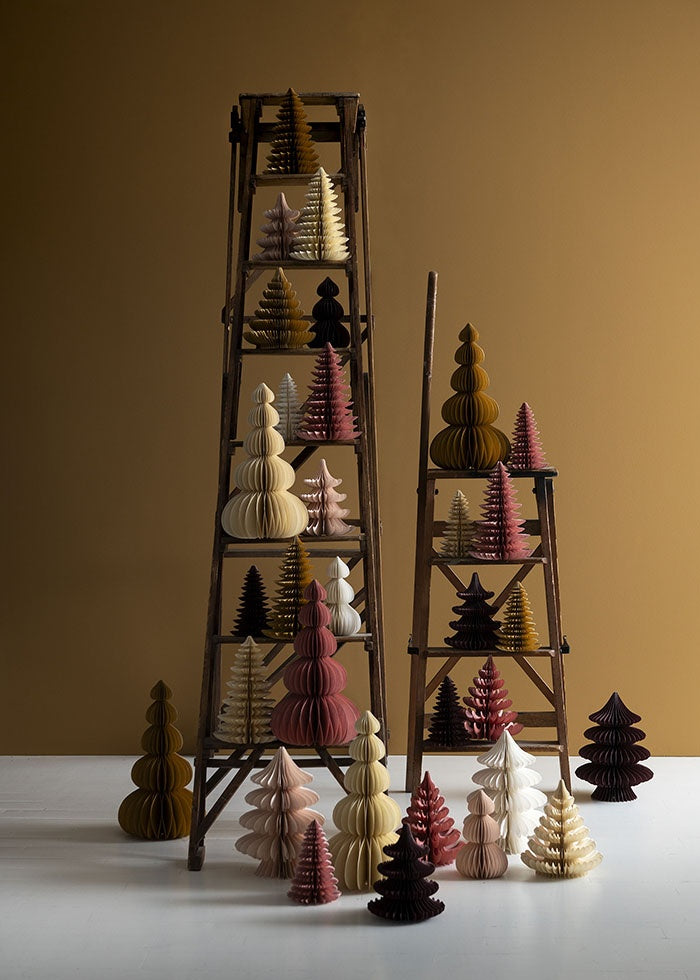 Collection of paper honeycomb trees in various shapes and earthy tones displayed on two wooden ladders
