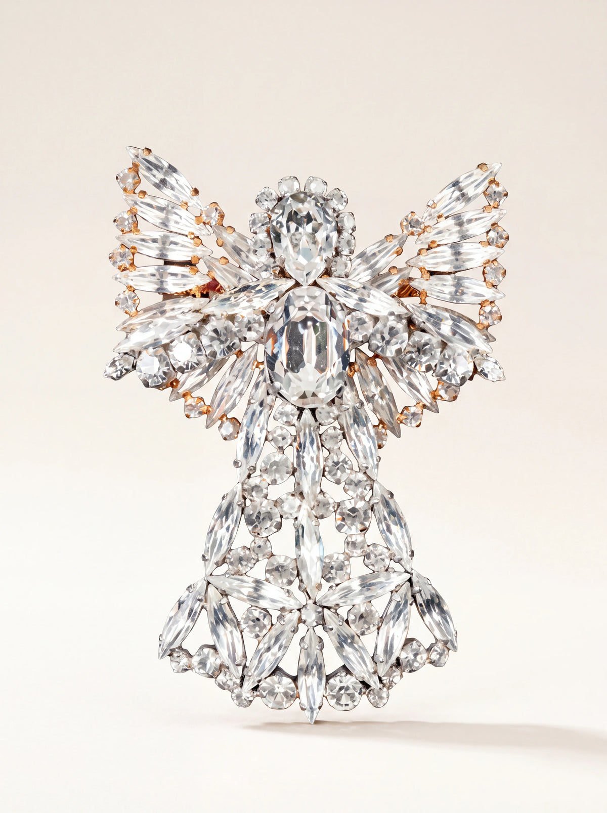 Angel brooch with clear faceted marquise, oval and round glass crystals in a gold-toned setting