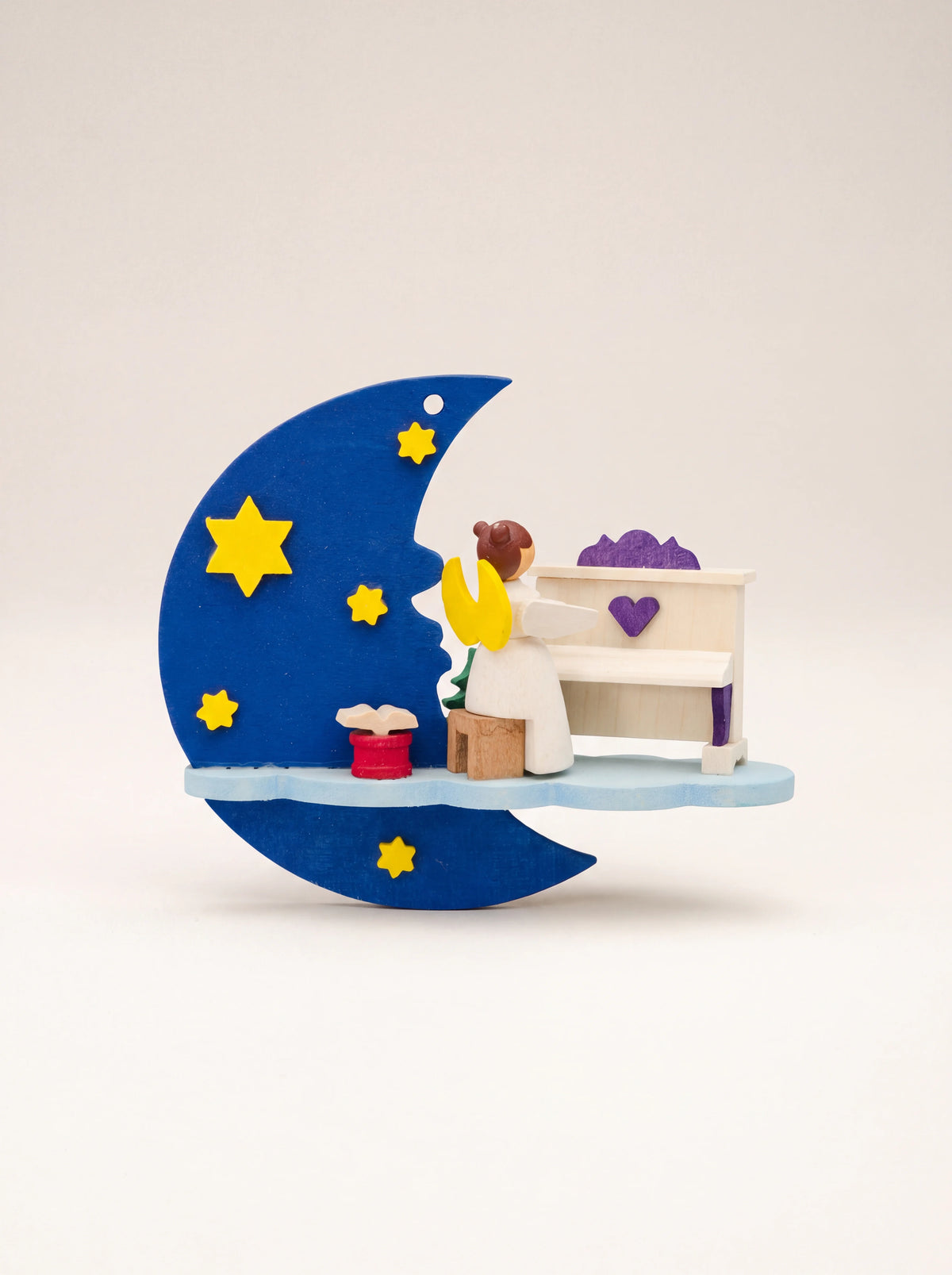 Painted sycamore wood angel ornament playing an upright piano on a cloud beside a blue crescent moon with stars