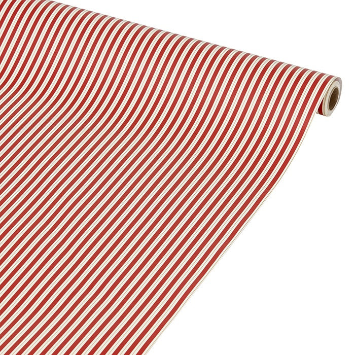 Roll of wrapping paper partially unrolled, showing narrow scarlet red and off-white stripes