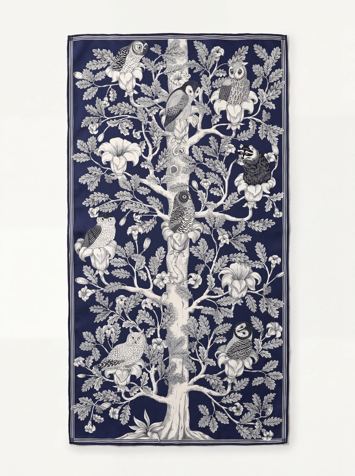 Rectangular navy wool scarf featuring an illustrated tree with owls and flowers within a striped border