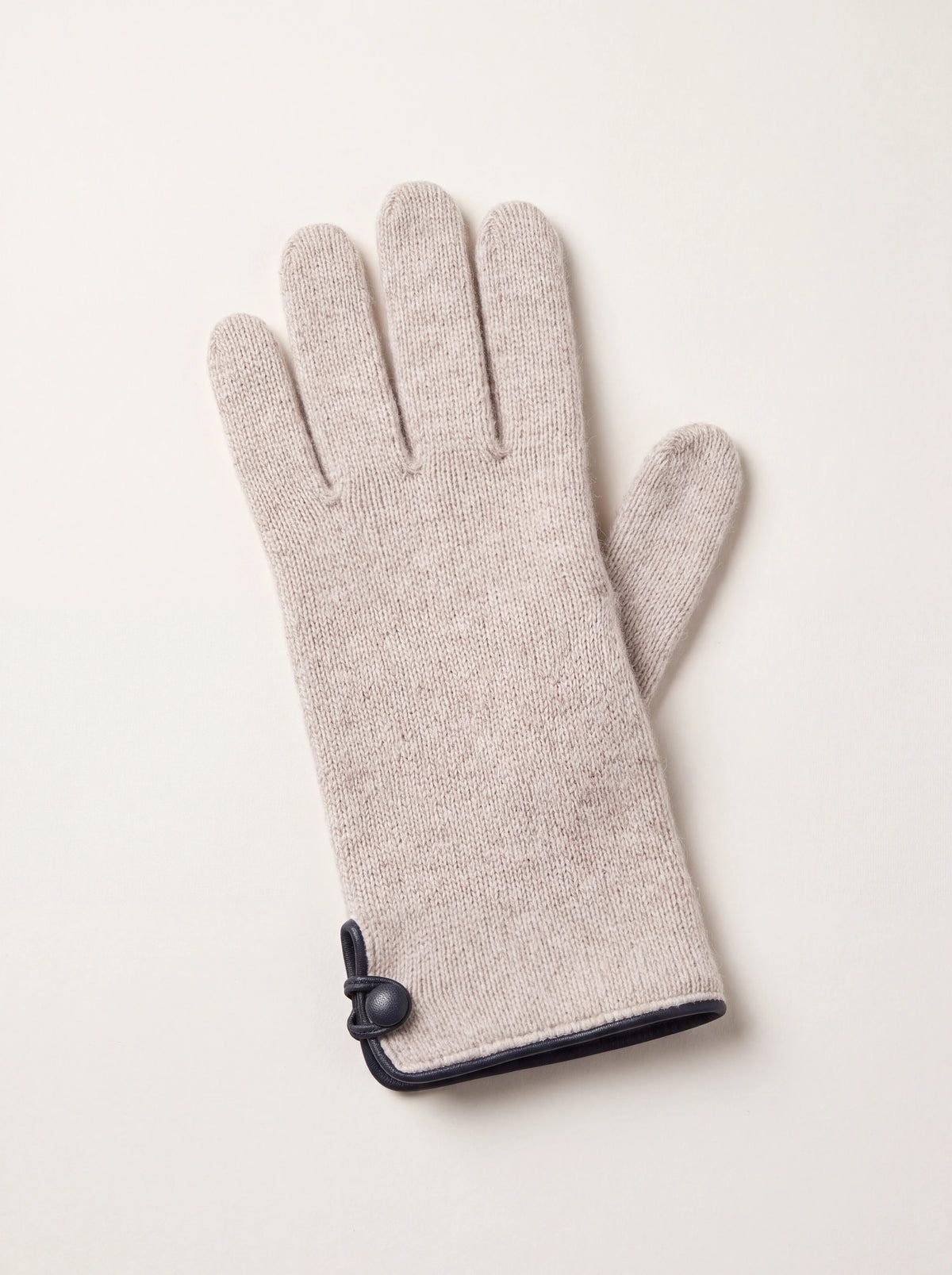 Knitted wool and cashmere glove in light beige with dark trimmed hem and covered button cuff