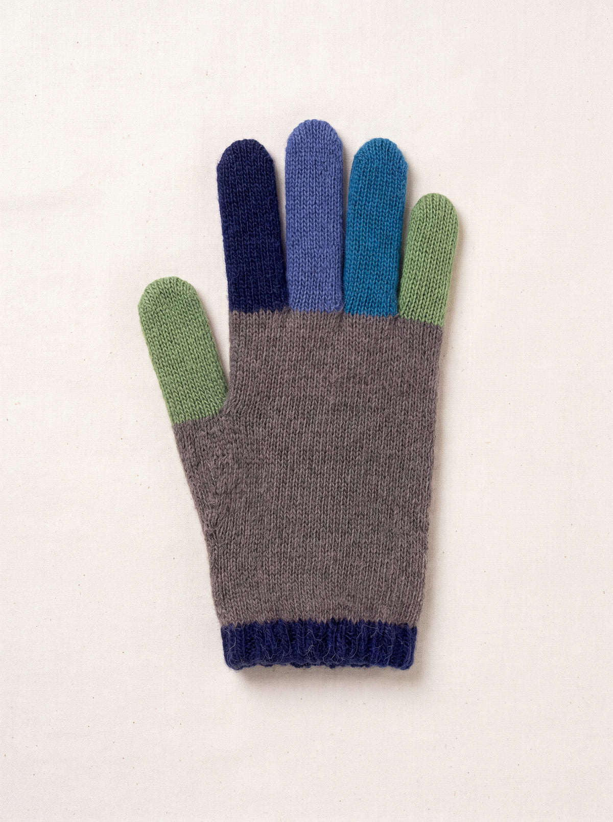 Knitted wool and cashmere glove with grey hand, colourful blue and green fingers, and a ribbed navy cuff