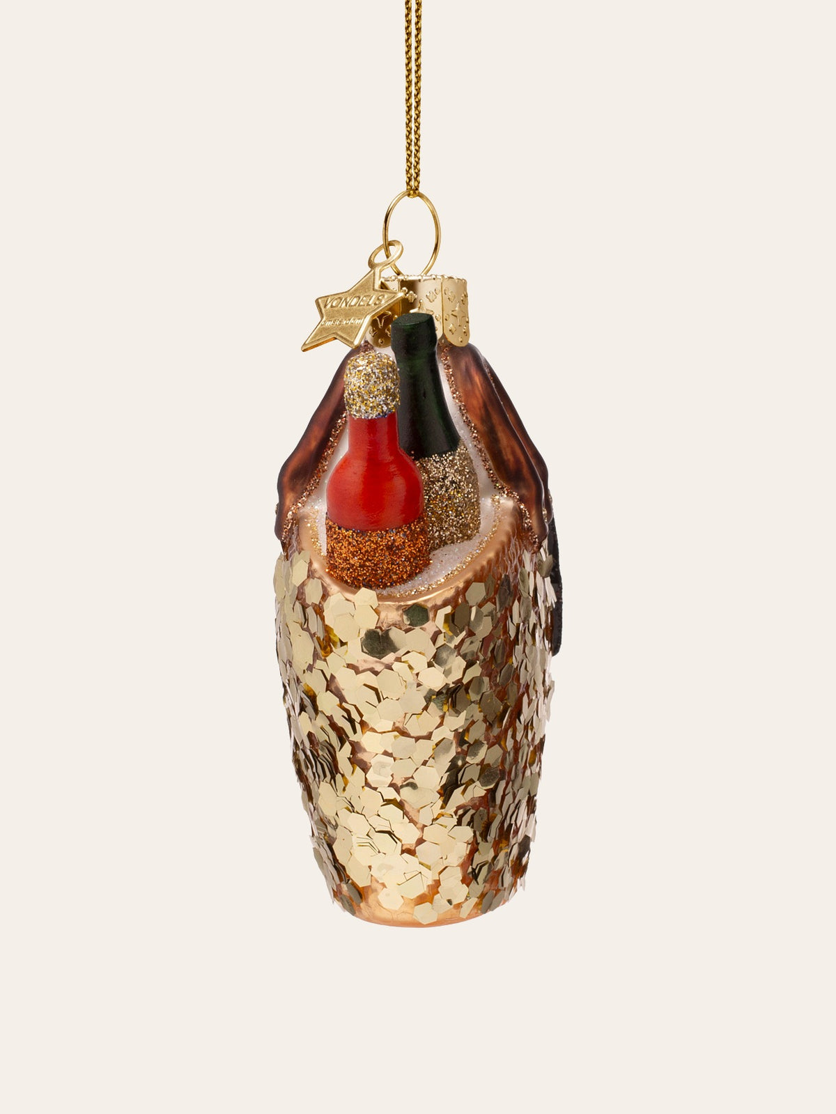 Side view of the glass beach bag ornament showing its slim profile and the two glittery bottles