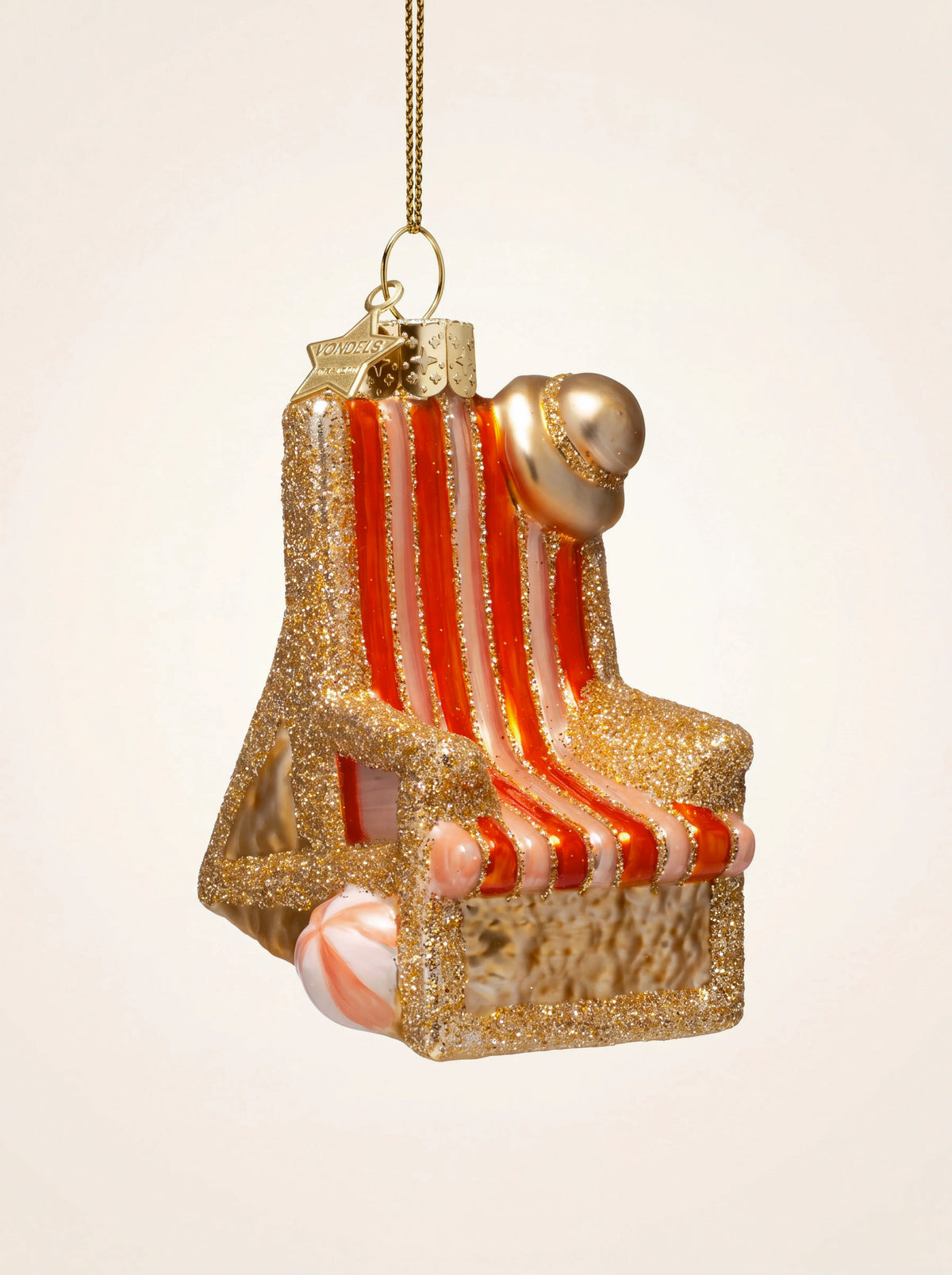 Glass beach chair ornament with gold glitter frame, red-striped seat, sun hat and beach ball