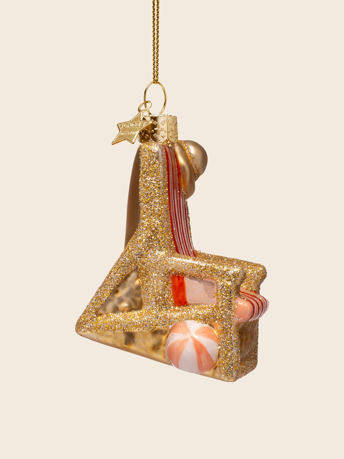 Side view of the beach chair ornament showing the glittered triangular frame and beach ball beneath