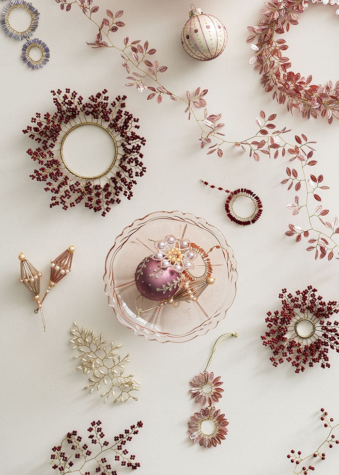 Beaded hoop ornament shown flat alongside coordinating pink and red beaded decorations