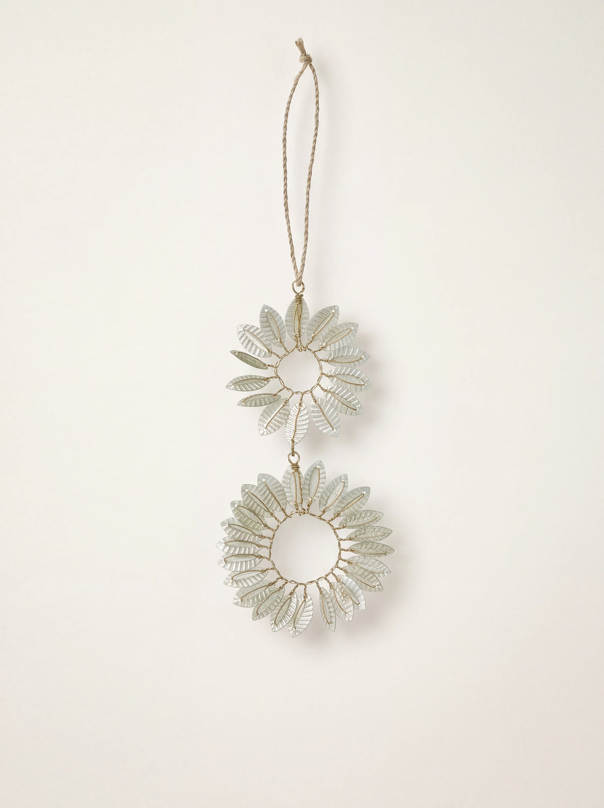 Pale green beaded hoop ornament with two joined wire rings and radiating leaves on a hanging cord