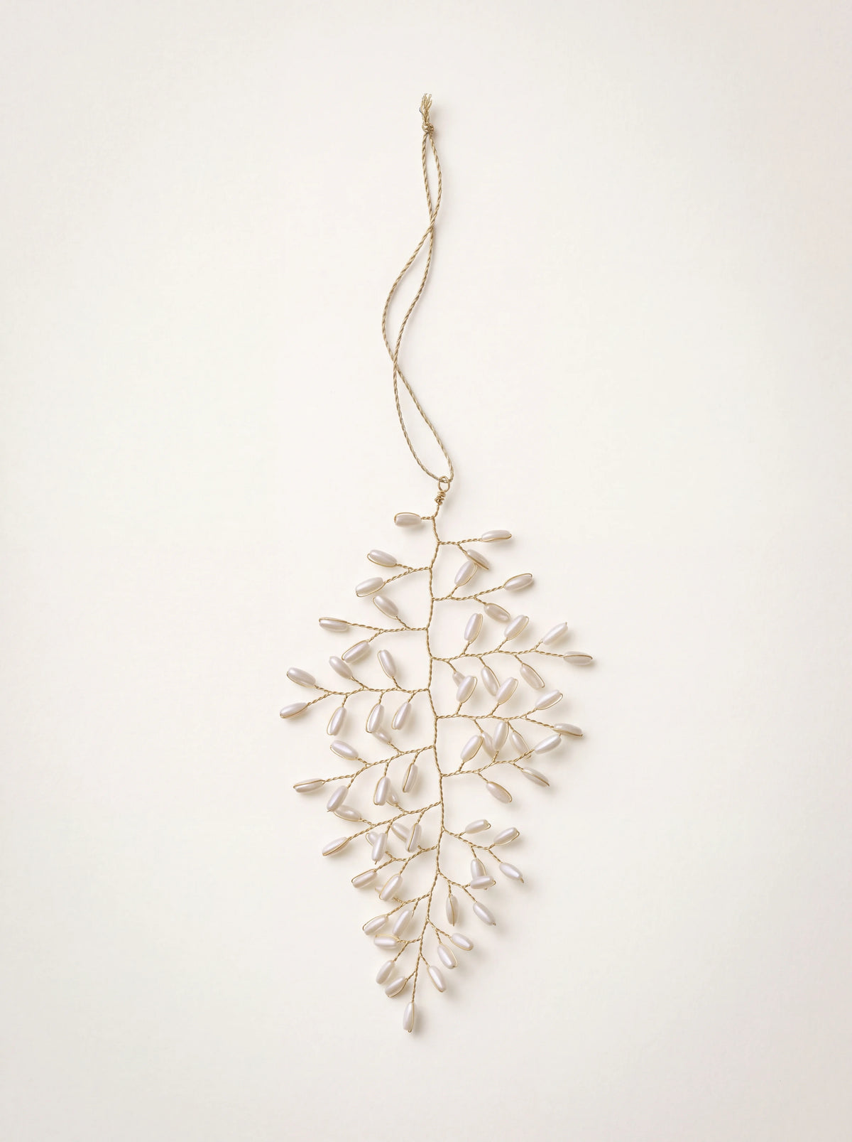 Leaf-shaped hanging ornament with twisted wire branches and cream pearl beads