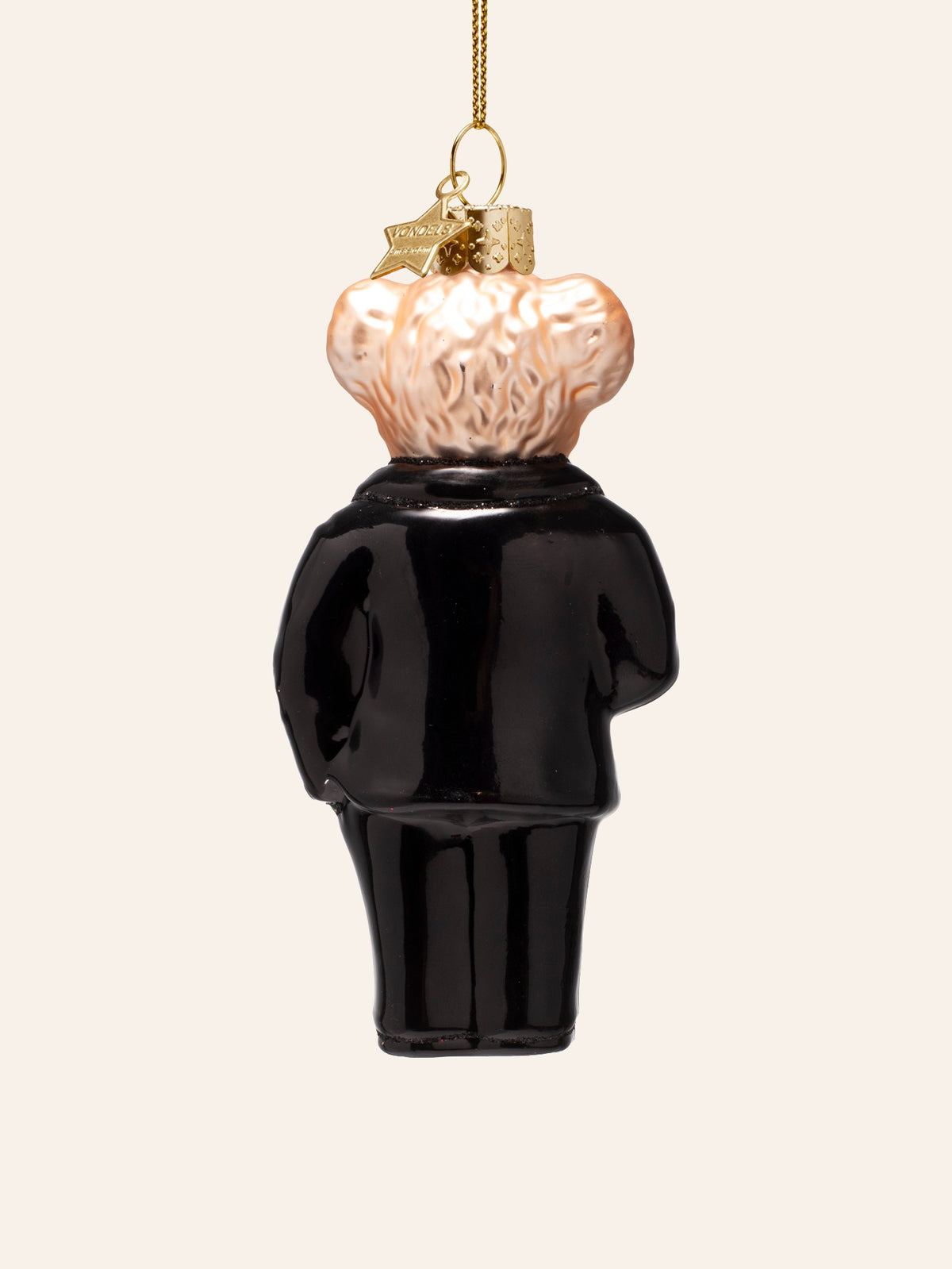 Rear view of the glass bear ornament, showing the textured fur and back of the black tuxedo