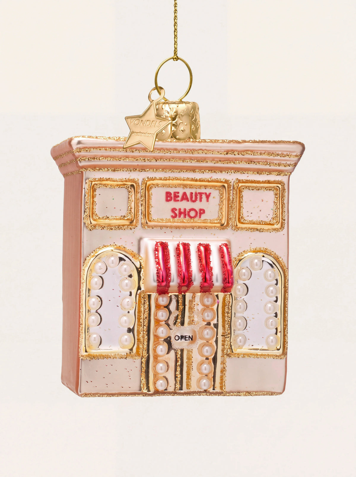 Pink glass beauty shop ornament with glitter trim, pearl detailing and a red-striped awning