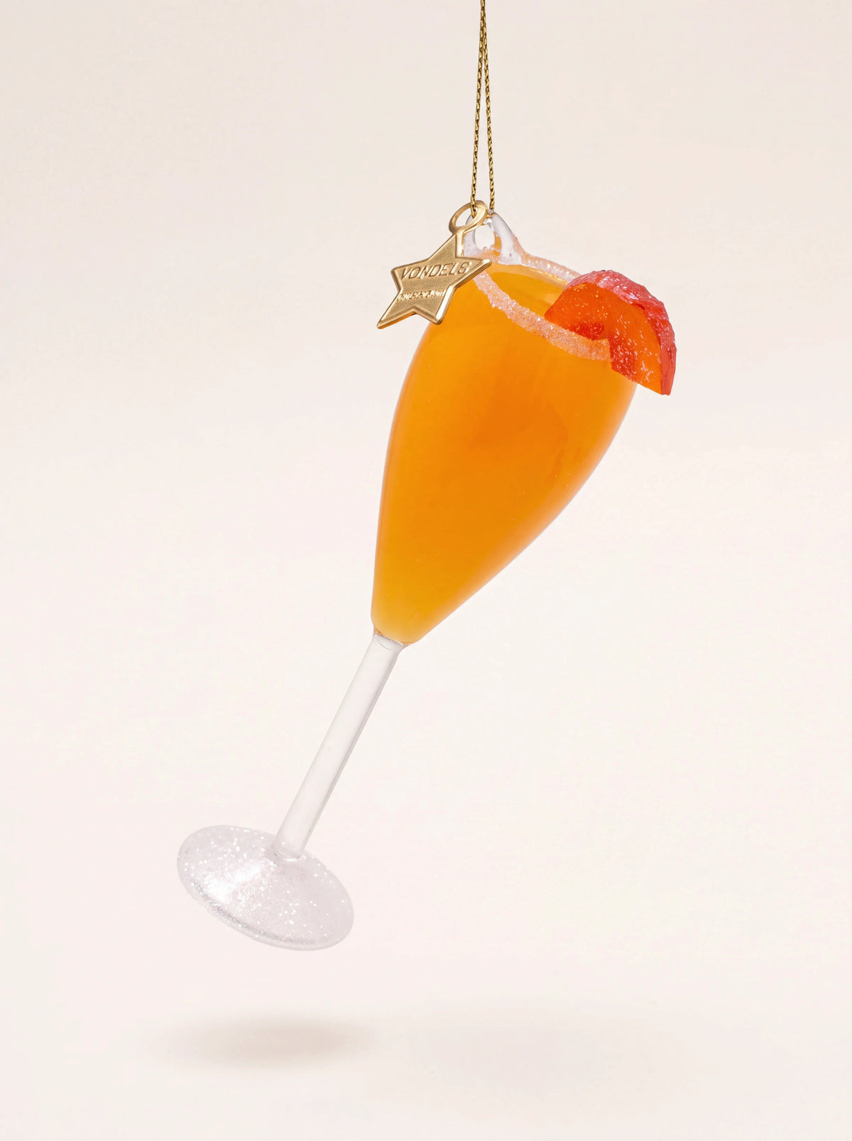 Glass Bellini cocktail Christmas ornament in a flute with an orange fill, peach slice, and glittered base