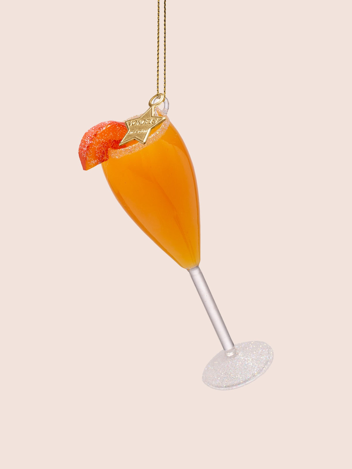 Reverse side of the glass Bellini ornament tilted right, showing the peach garnish and star tag
