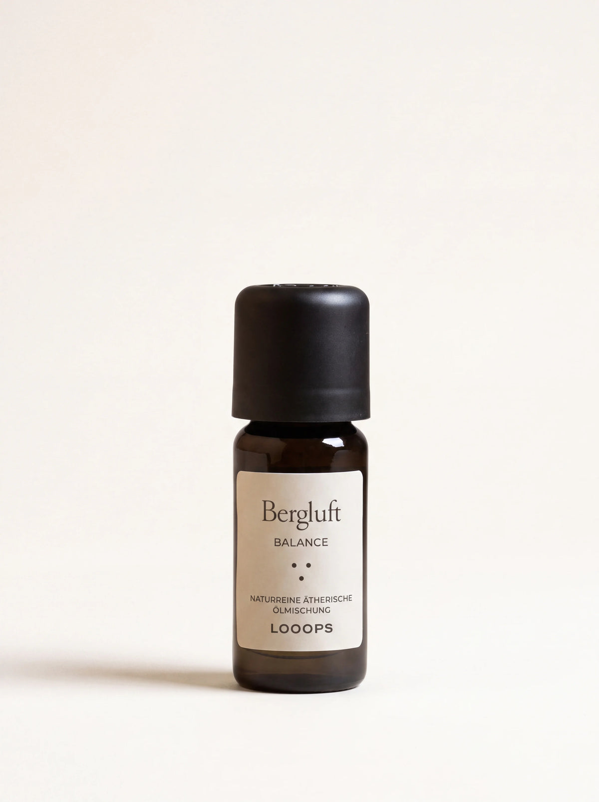 Amber glass essential oil bottle with a black cap and label reading Bergluft Balance
