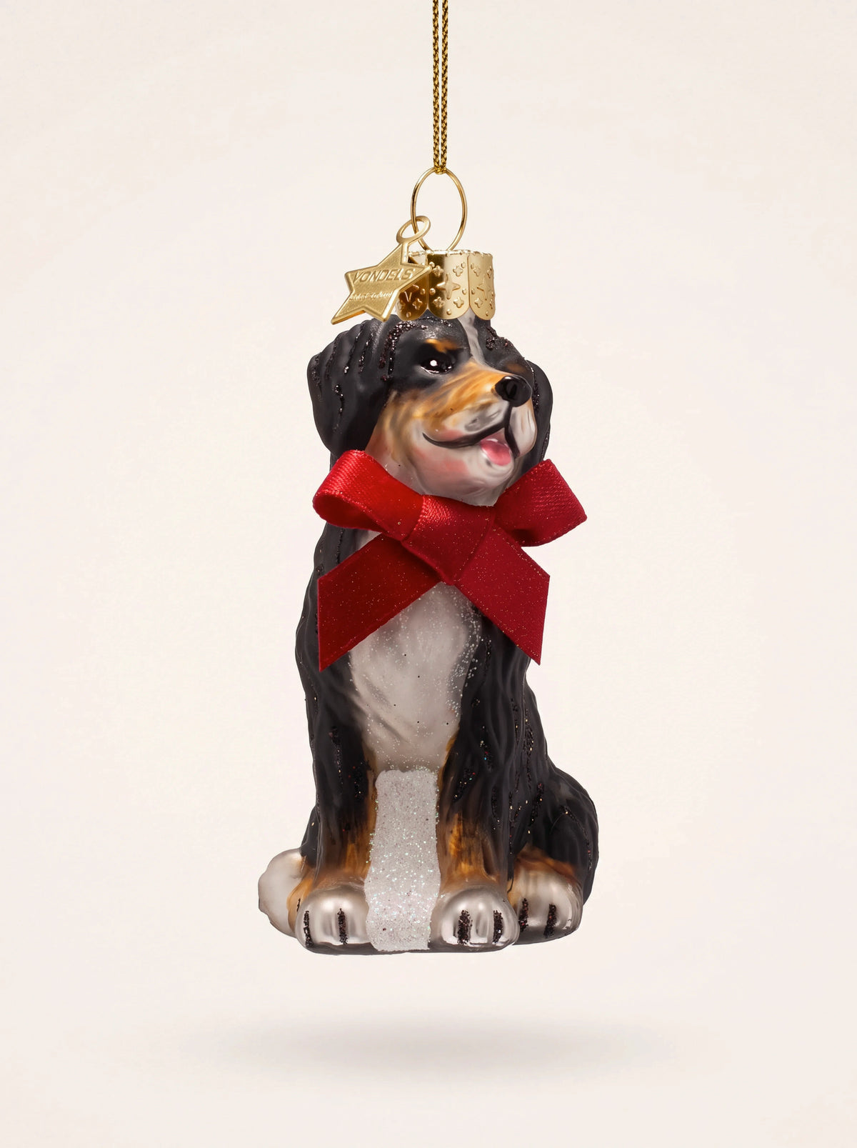 Bernese mountain dog glass ornament with a red bow, glitter details and a gold hanging loop