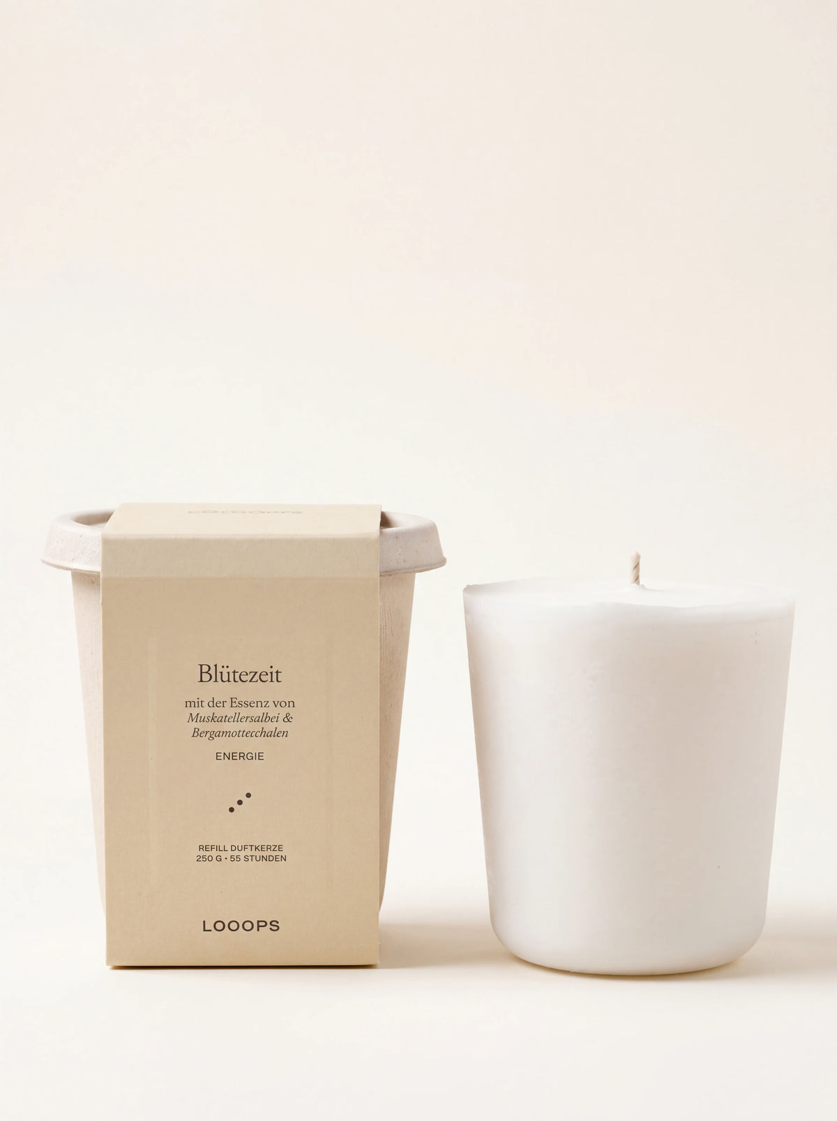 White vegetable wax candle refill beside its compostable cup packaging labelled Blütezeit