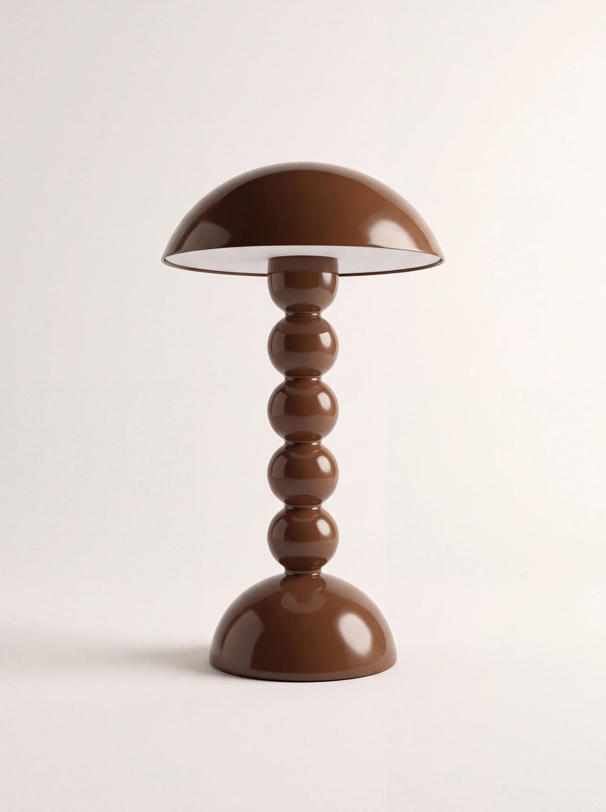 Chocolate brown bobbin table lamp with a glossy finish, dome shade and stacked bead stem