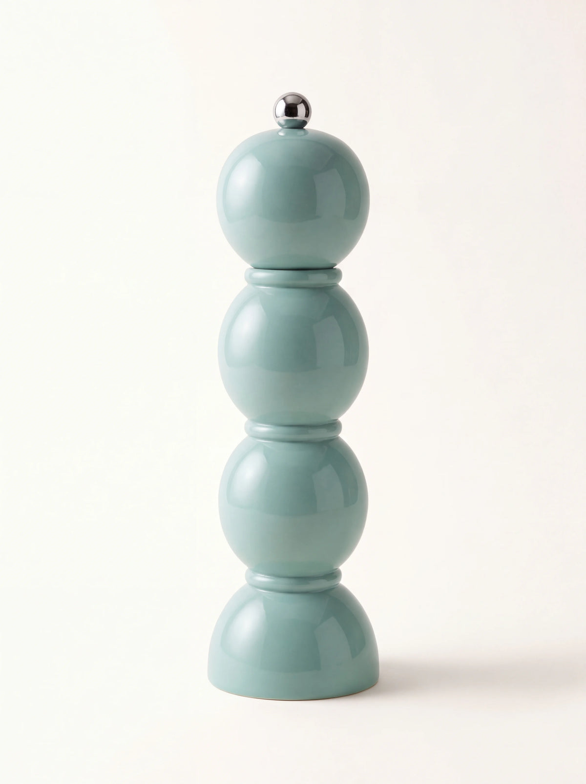 Eau de Nil lacquered wooden grinder with a stacked spherical bobbin design and silver top knob