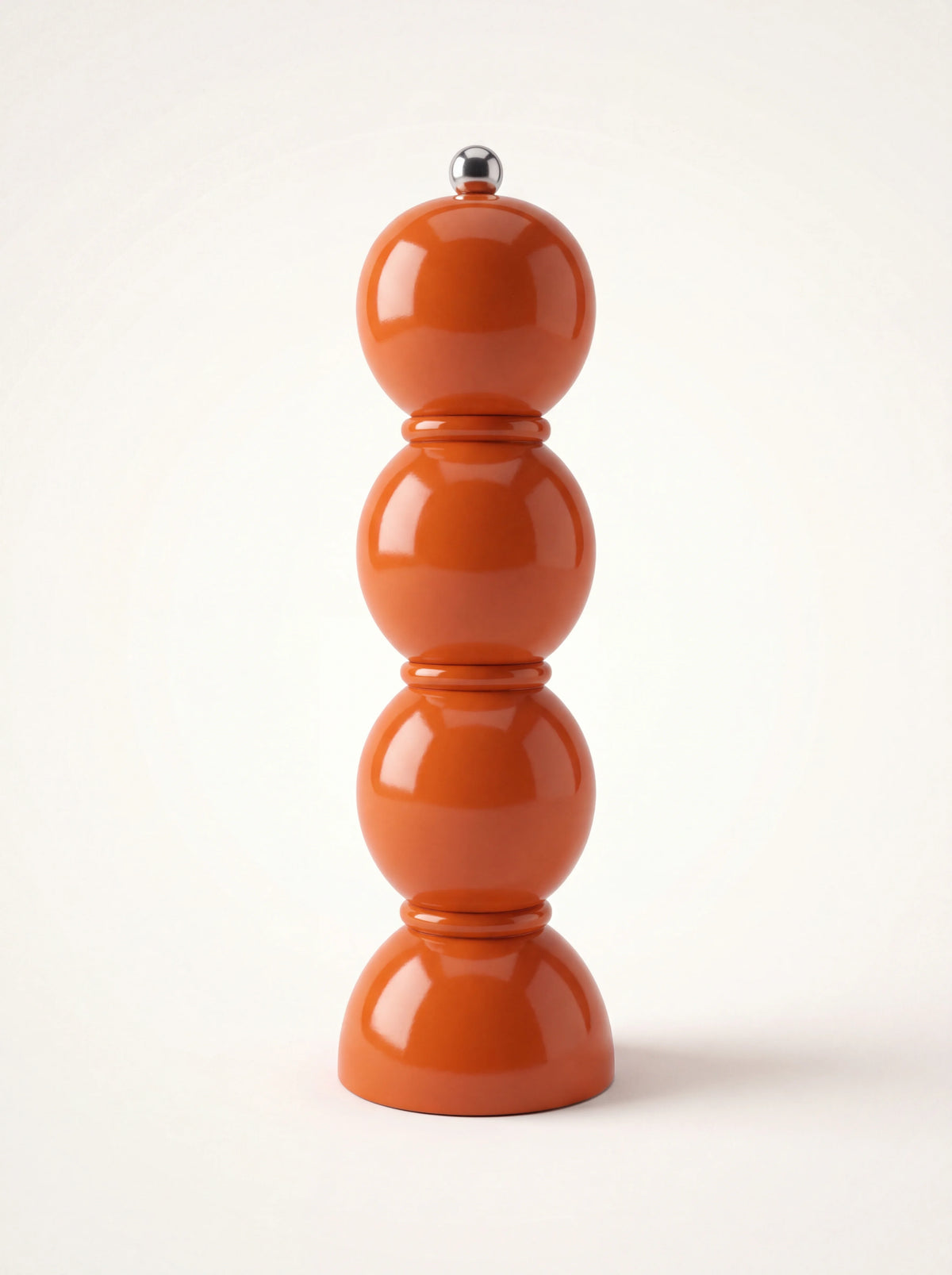 Bobbin salt or pepper grinder in high-gloss orange lacquered wood with a stainless steel knob