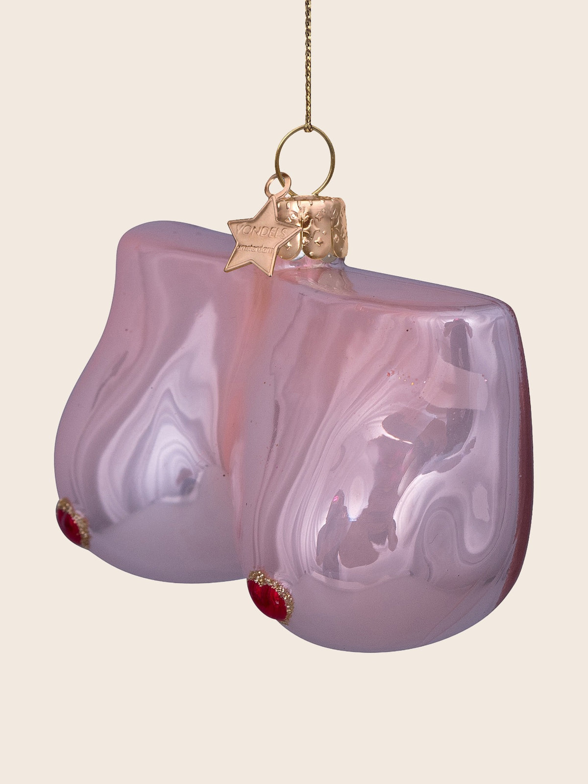 Three-quarter view of the pink glass breast ornament showing its curved depth