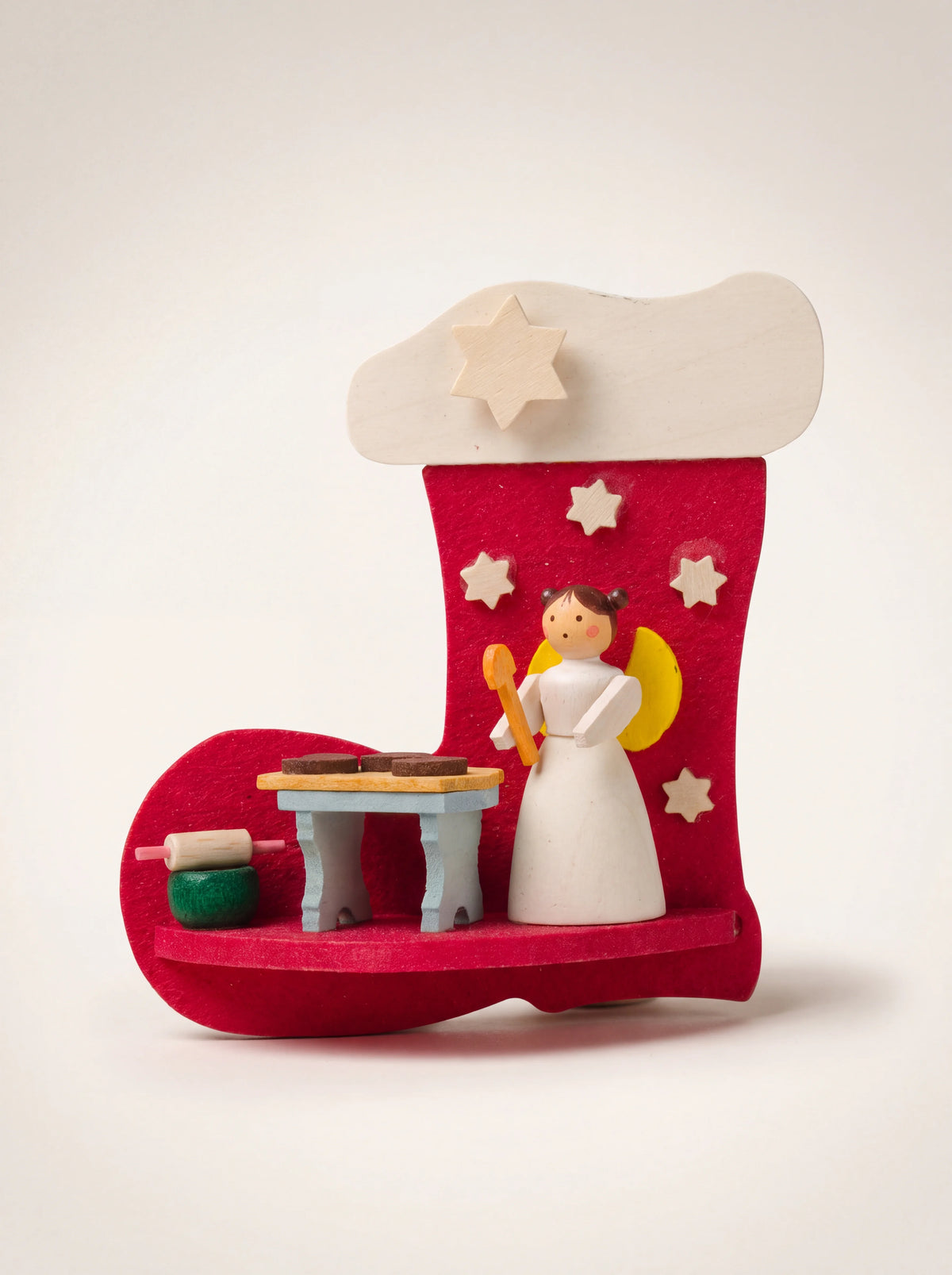 Wooden boot Christmas ornament in red with an angel figurine baking at a miniature table