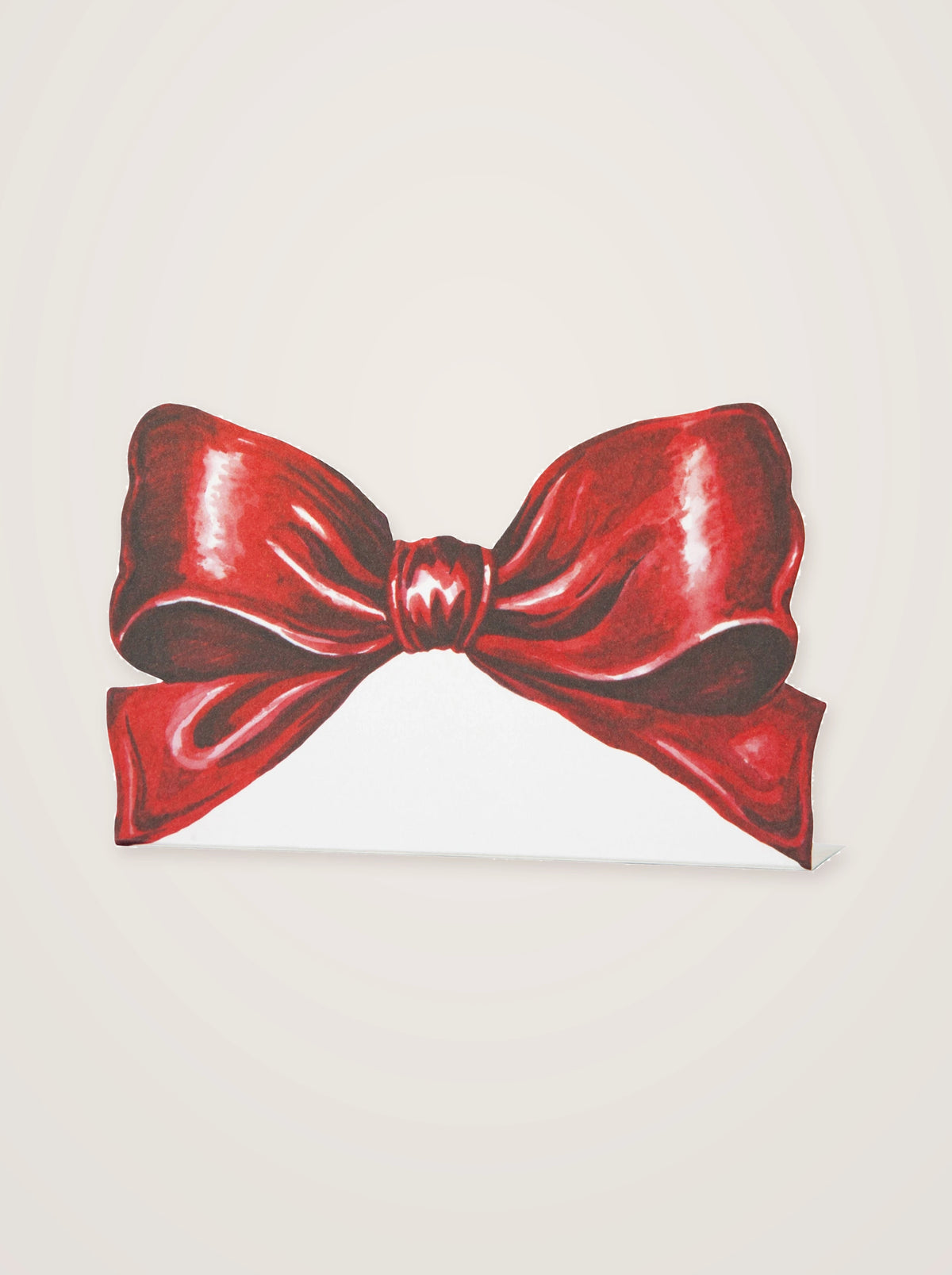 Paper place card printed with an illustrated red ribbon bow above a blank section for guest names