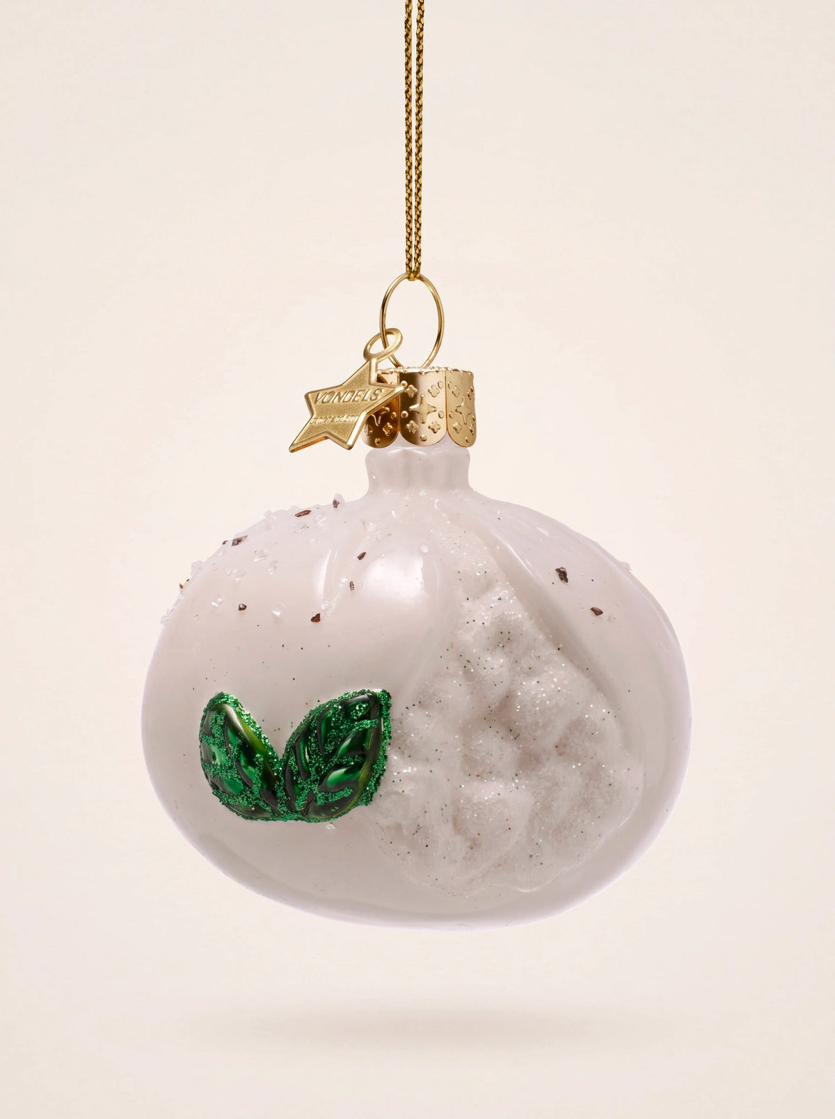 Burrata cheese glass ornament with a textured open filling, green basil leaves and a gold hanging loop