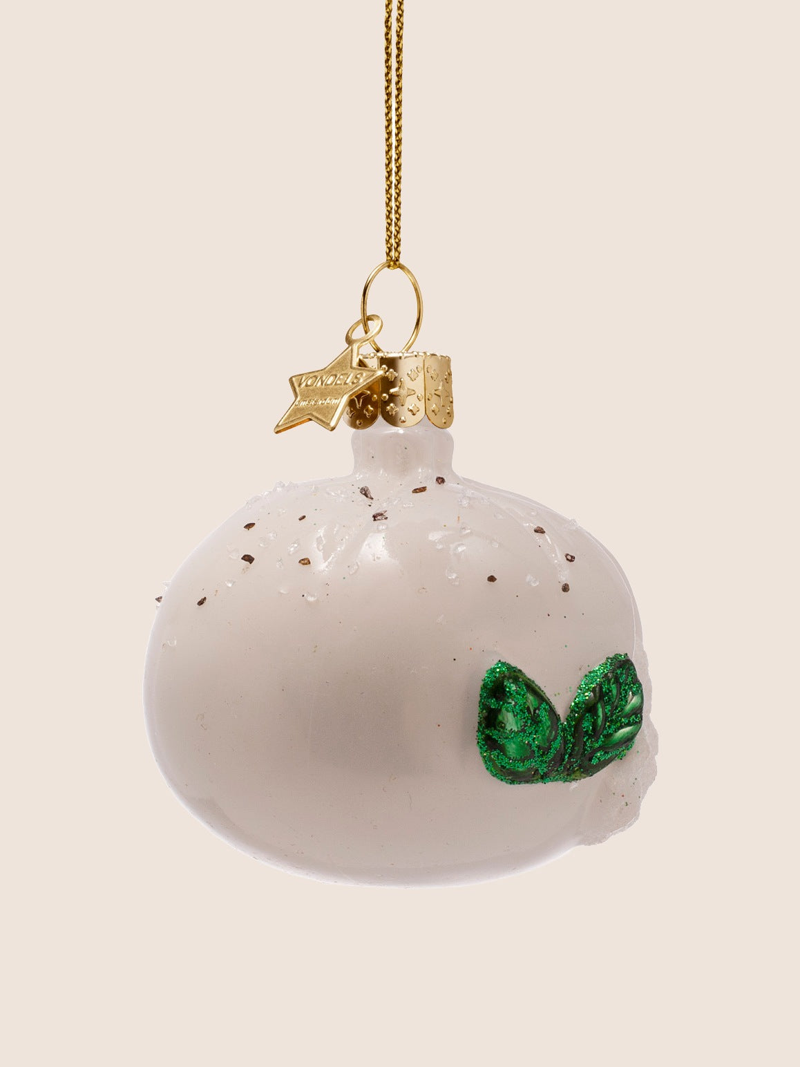 Side view showing the smooth white glass exterior, glittery green basil leaves and speckled details on top