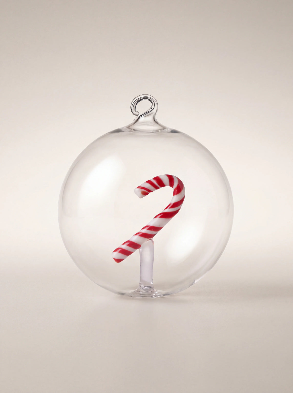 Clear glass bauble with a red and white striped candy cane inside and an integrated hanging loop