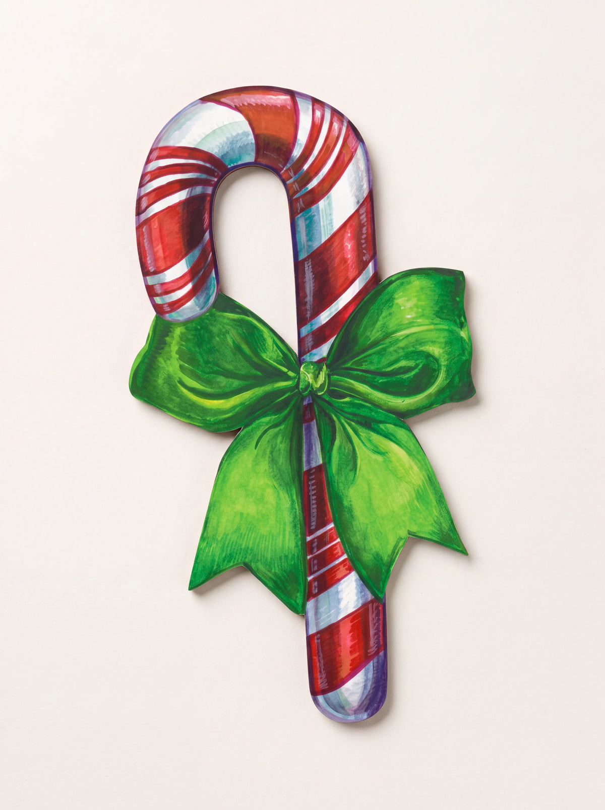 Paper candy cane table accent with red and white stripes and a green bow