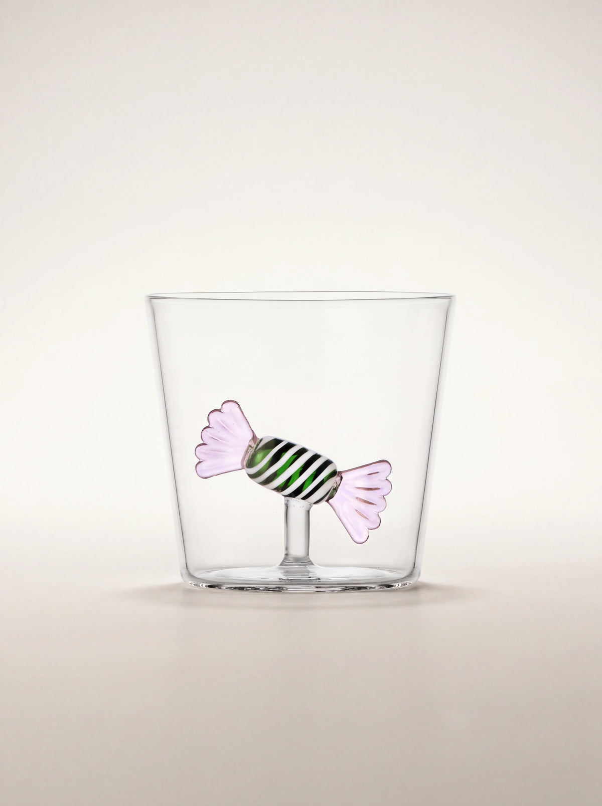 Clear borosilicate glass tumbler with an internal green-striped sweet figure with pink ends on a stem