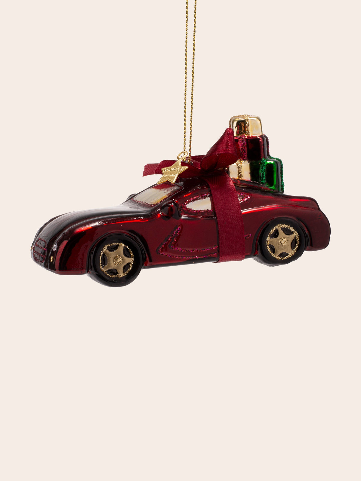 Opposite three-quarter view showing the glitter wheel rims and gold star charm