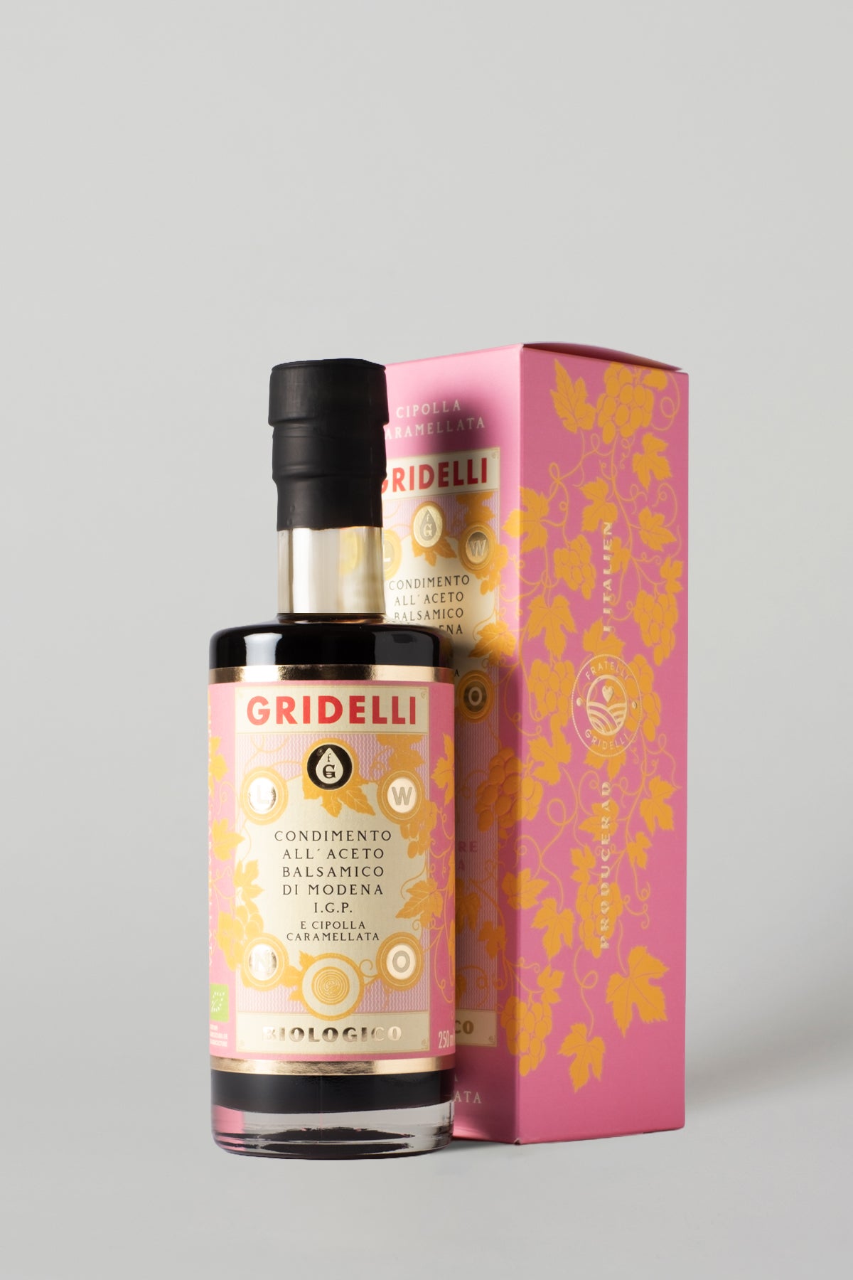 Caramelised onion balsamic vinegar bottle standing beside its pink illustrated packaging box