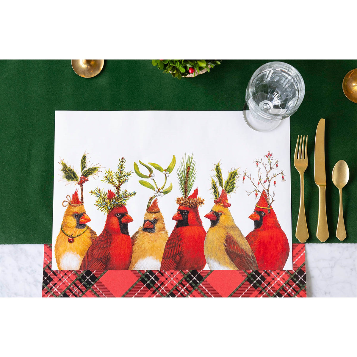 Cardinal paper placemat styled on a green table setting with gold cutlery, glassware and a tartan mat