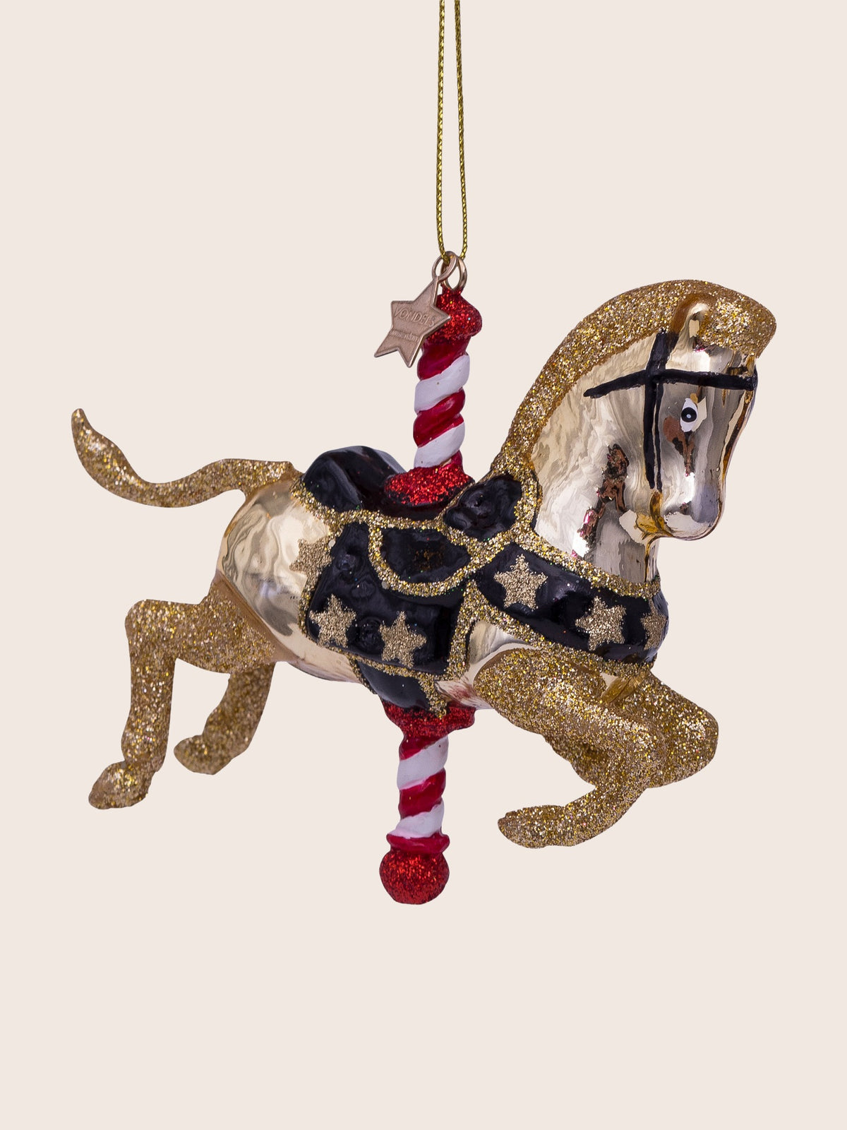 Three-quarter view highlighting the black saddle and harness decorated with gold glitter stars