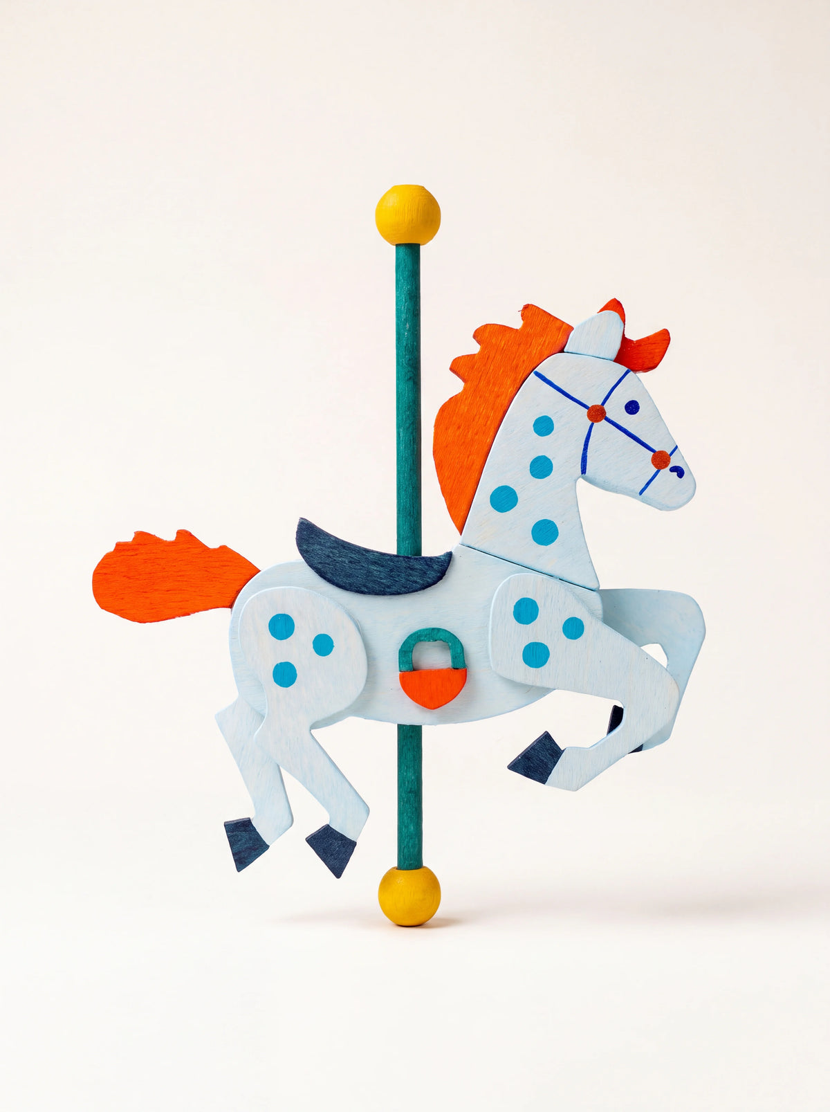 Maple wood carousel horse ornament in light blue with an orange mane and tail mounted on a green pole
